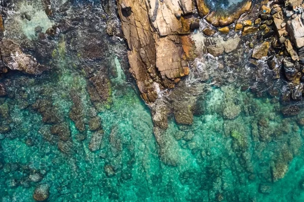 kayak adventure aerial rocky coast turquoise water